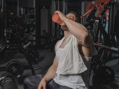 Glass bottle of water on a bench in gym