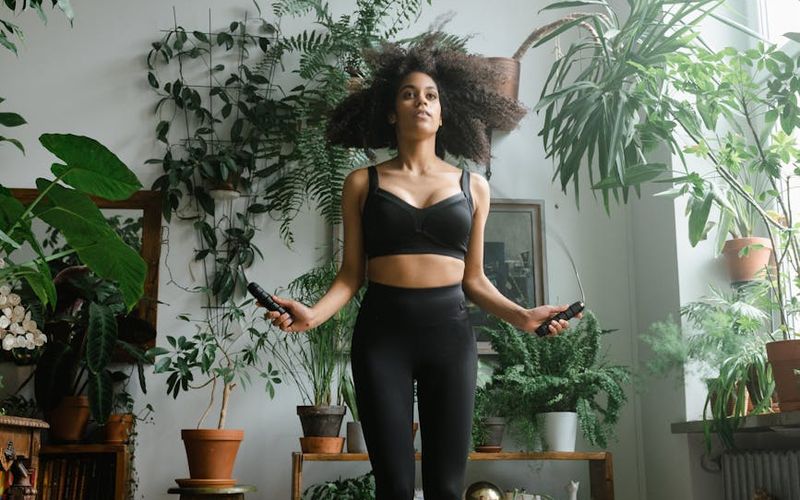 Person using a jump rope in a minimalist studio